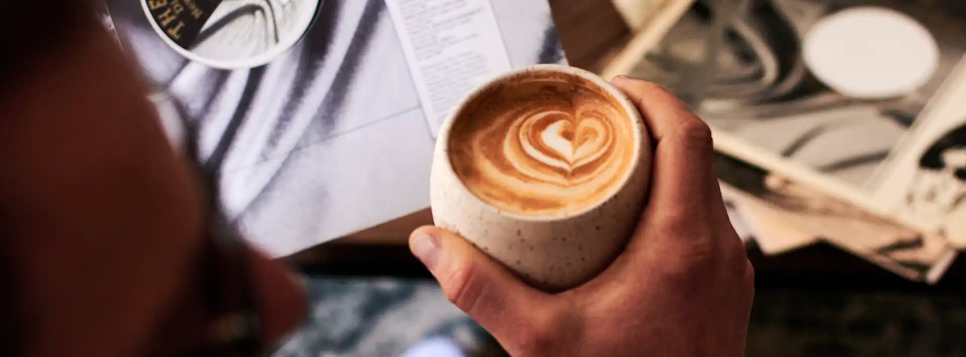 Ground Coffee Society hand holding coffee