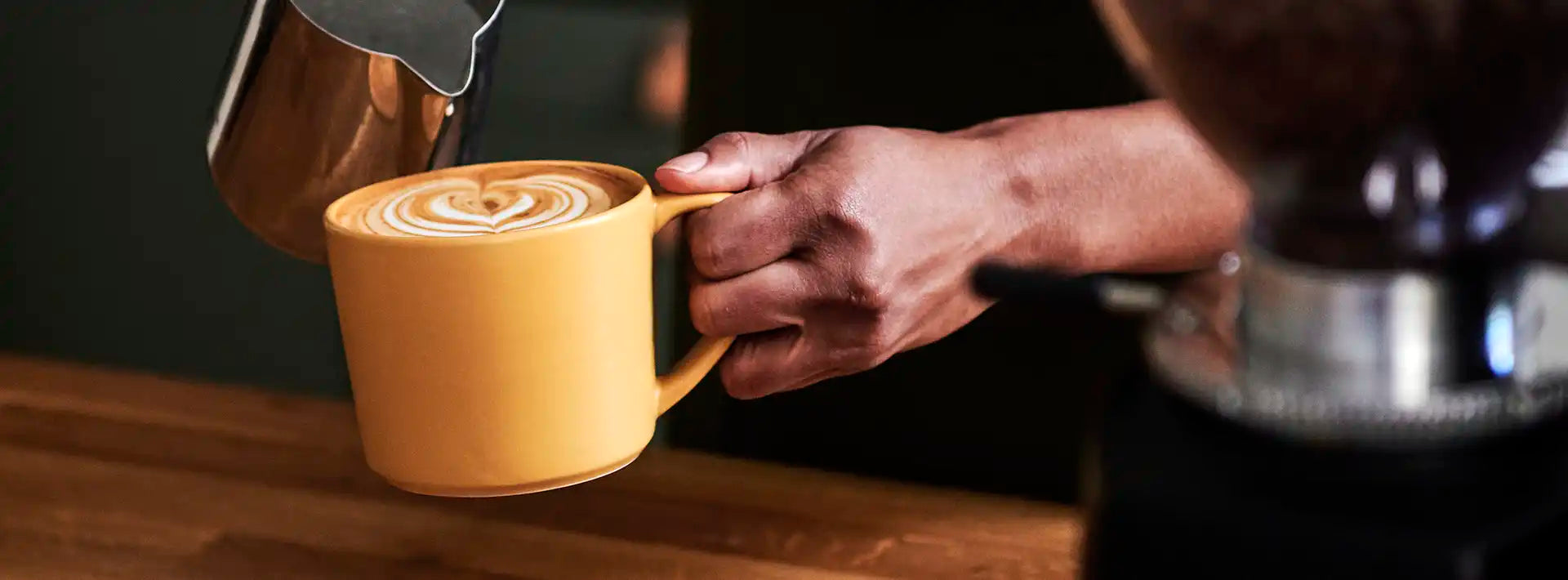 Ground Coffee Society hand holding coffee