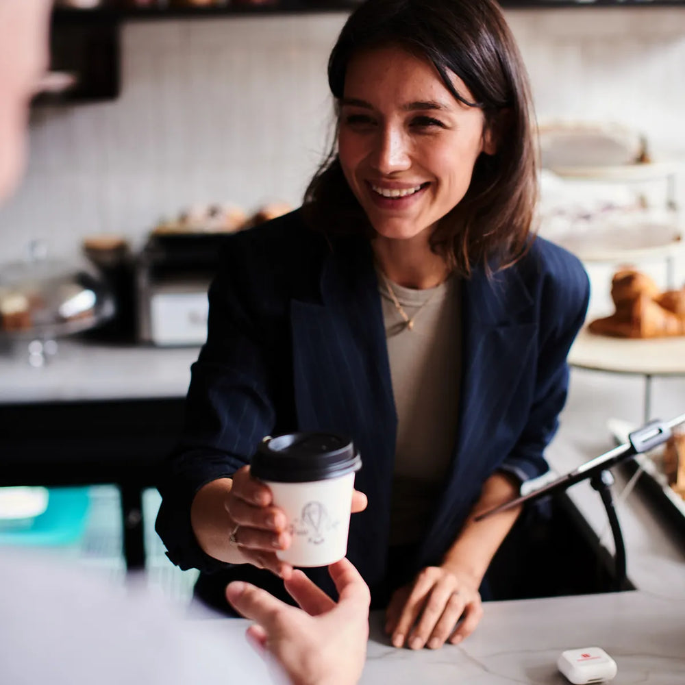 Ground Coffee Society wholesale coffee – barista serving coffee in Cafe Press London