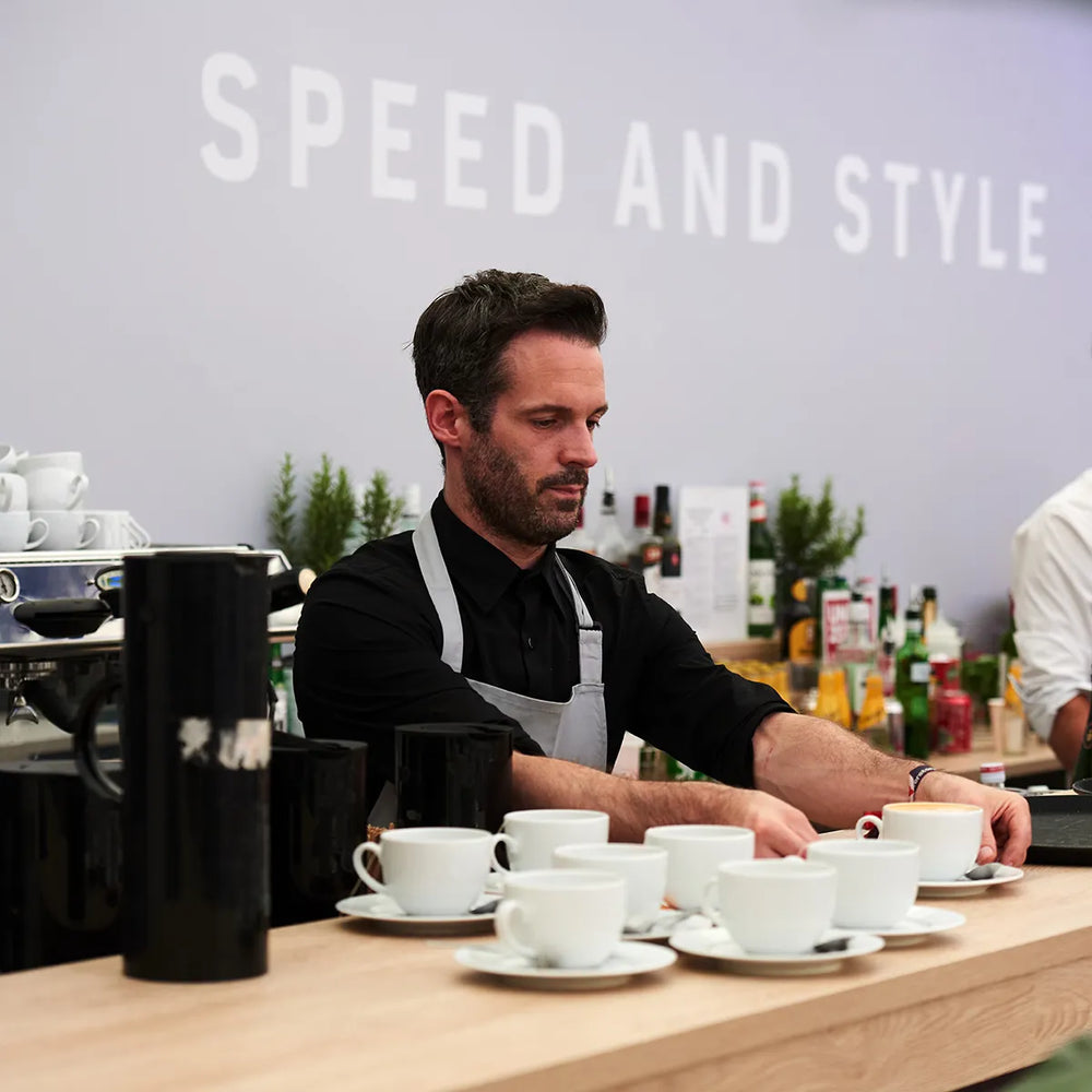 Ground Coffee Society wholesale barista serving coffee at Silverstone F1 event